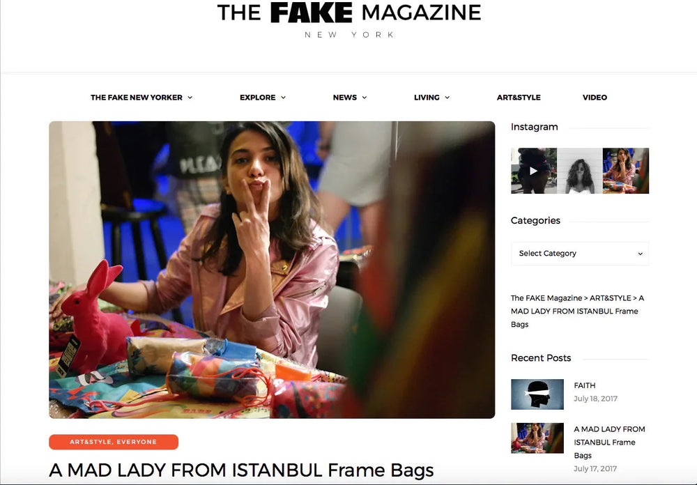 Woman in pink jacket making peace sign at a colorful art and style event with vibrant bags and a pink bunny