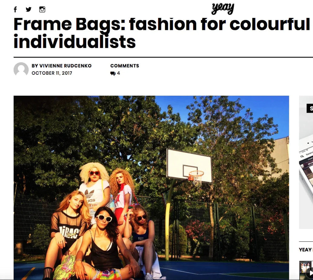 Fashionable young women with colorful frame bags posing on outdoor basketball court under blue sky