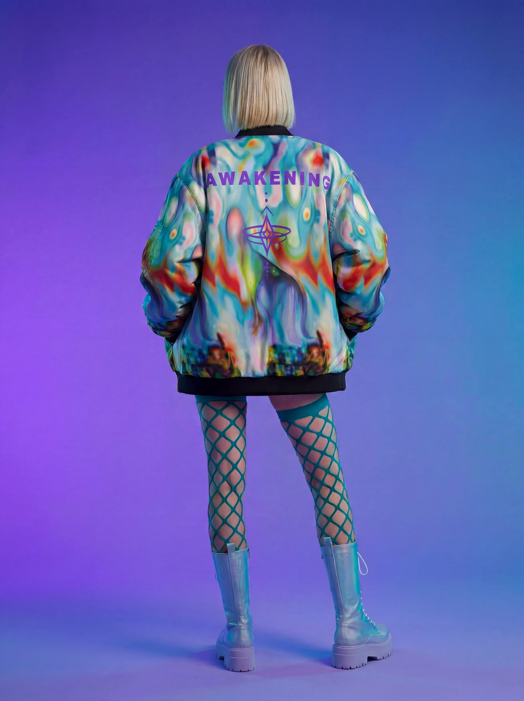 Person wearing a colorful jacket with 'AWAKENING' text on a gradient purple background