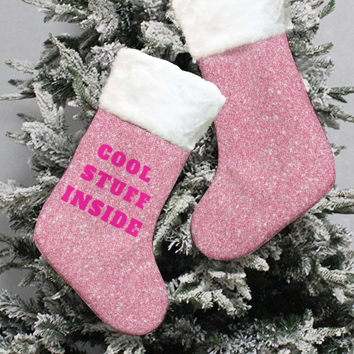 Pink glittery Christmas stocking with 'Cool stuff inside' text on a snowy branch background