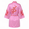 Pink robe with red designs on a white background