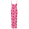 Pink slip dress with red star pattern on a white background