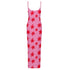Pink slip dress with red star pattern on a white background