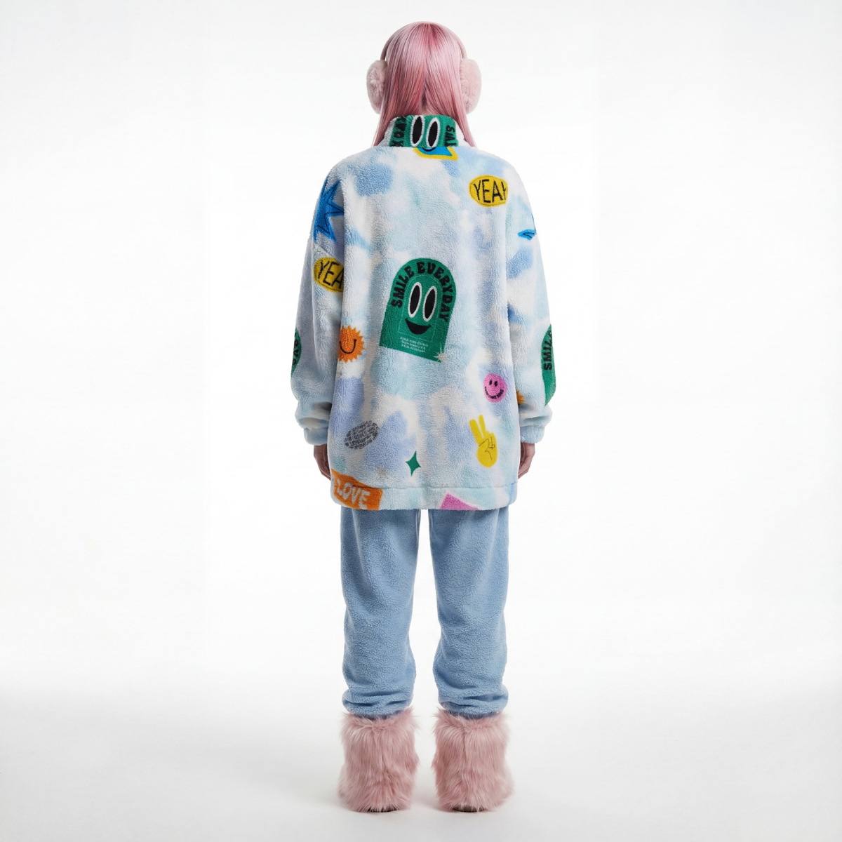 Person wearing a colorful jacket with cartoon designs on a white background