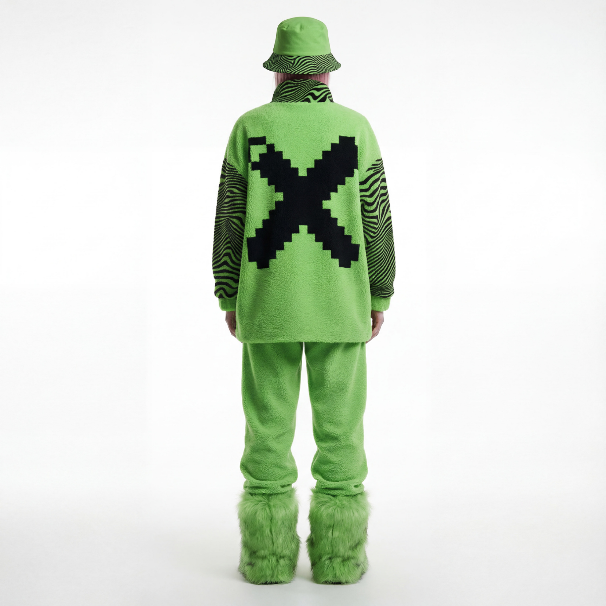 Person wearing a bright green outfit with a large black 'X' on a white background