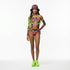 Model wearing a colorful one-piece swimsuit with long sleeves and a matching hat on a white background.