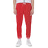 Red sweatpants worn by a person on a white background