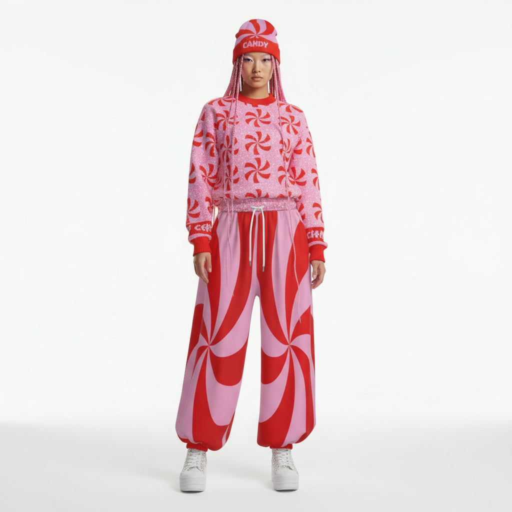 Person wearing a red and pink candy-themed outfit on a white background