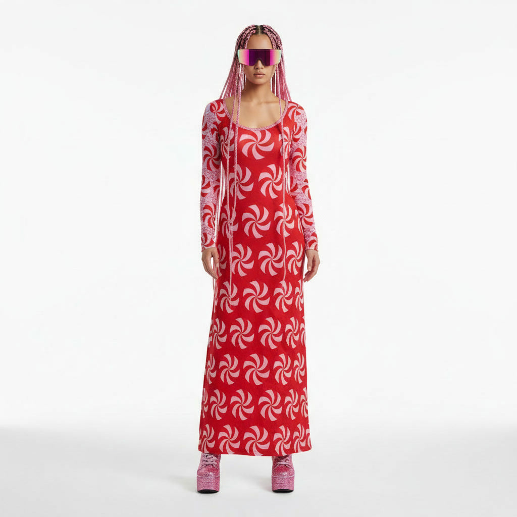 Person wearing a red and white patterned dress with matching shoes on a white background