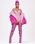 Person wearing a pink outfit with a fur stole and high boots on a white background