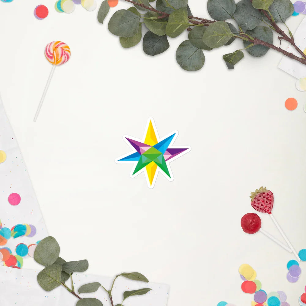 Colorful geometric star sticker on white background surrounded by green leaves, confetti, and lollipops